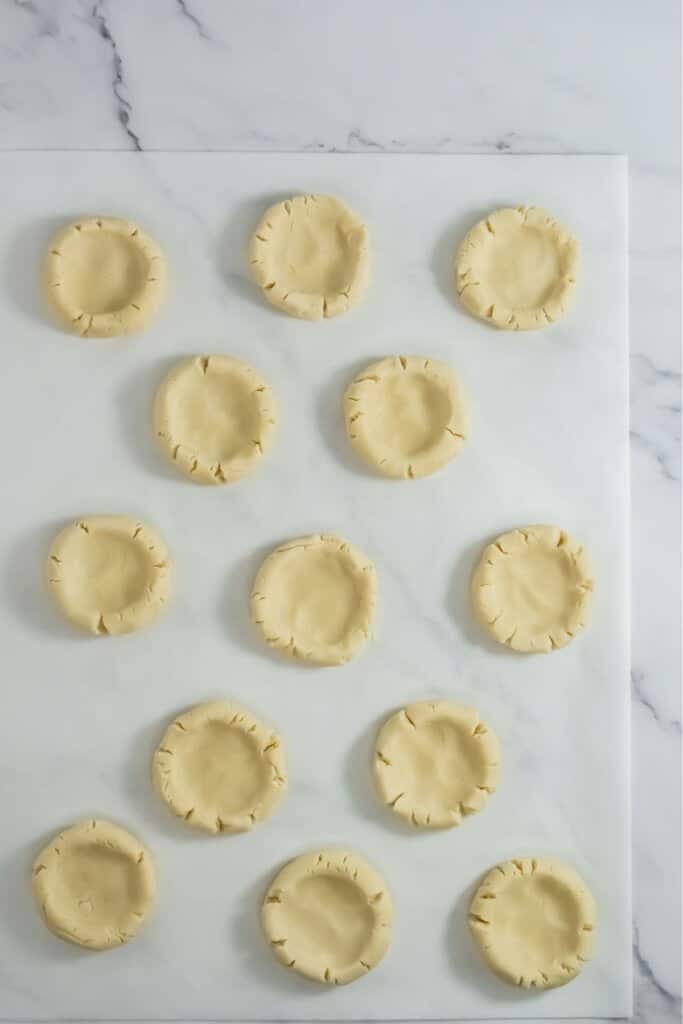 Dough on a parchment paper on a counter.