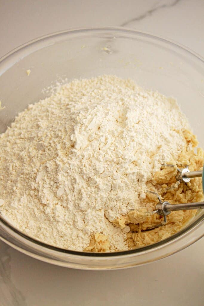 Dry ingredients being added to glass mixing bowl.