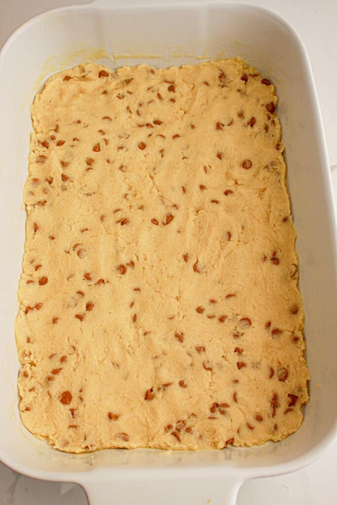 Dough being pressed in a taking dish.