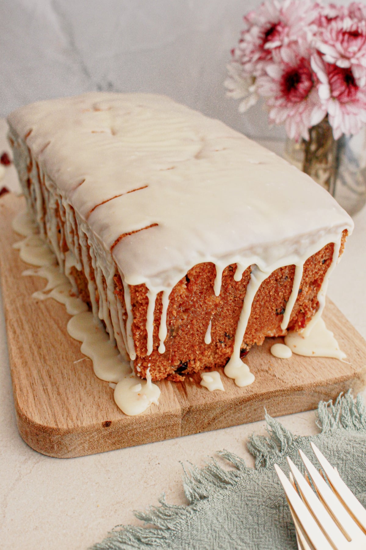 Cranberry white chocolate bread on a wooden cutting board.