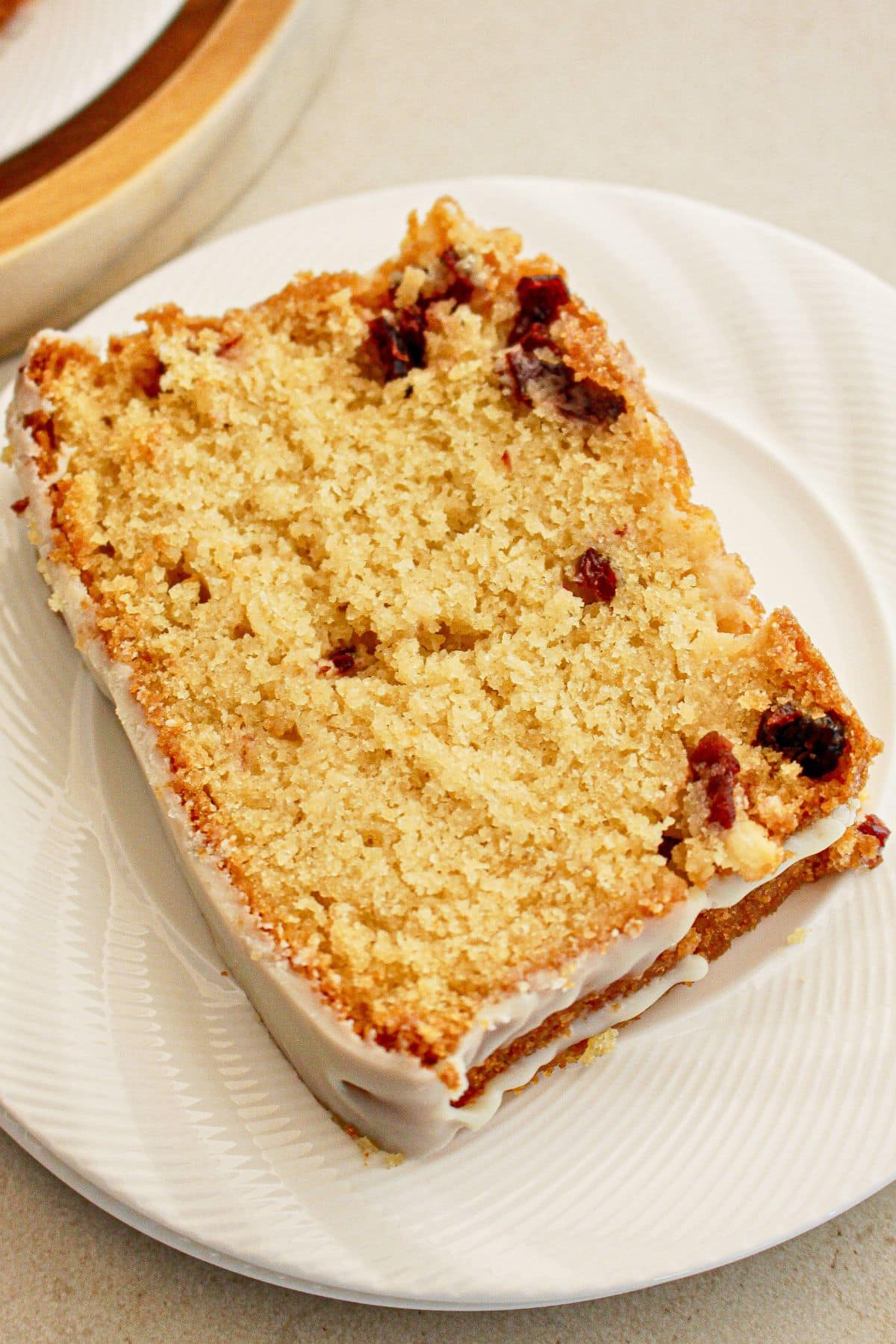Slice of cranberry white chocolate bread on a plate.