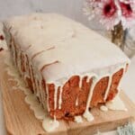 Cranberry white chocolate bread on a wooden cutting board.