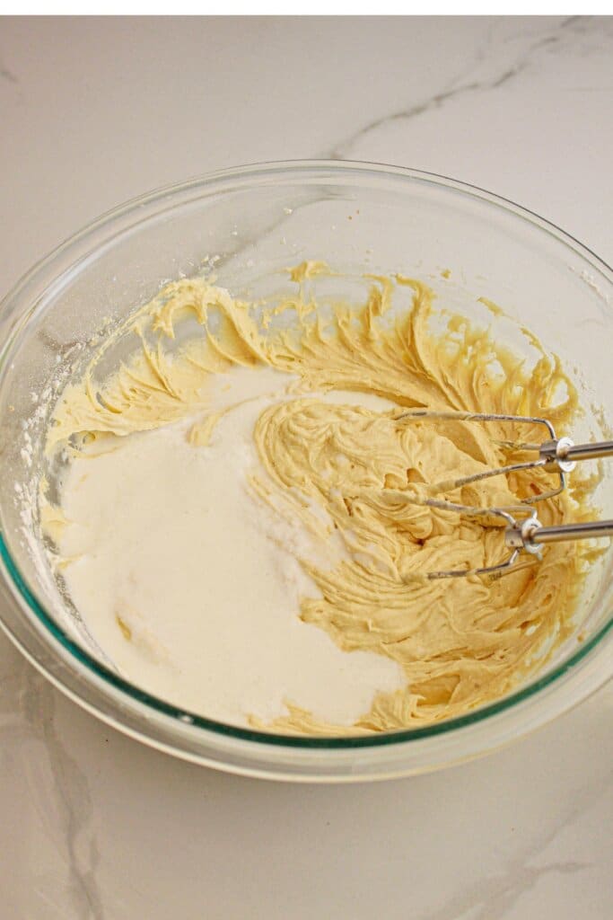 Batter being mixed in a glass bowl.
