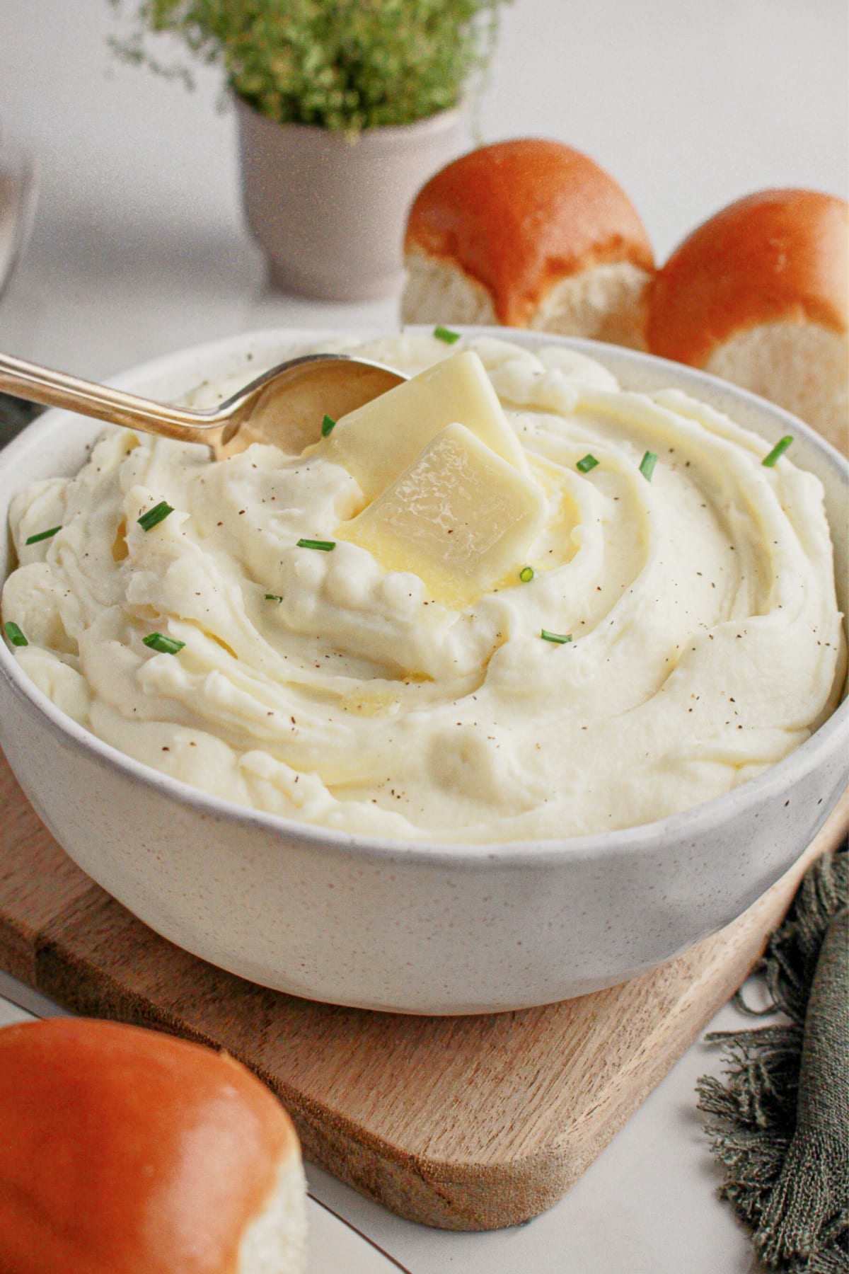 White bowl full of cream cheese mashed potatoes.