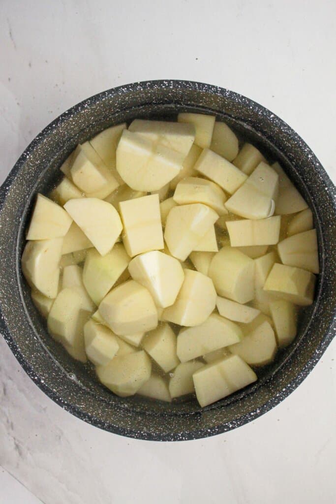 Raw potatoes in a pot.
