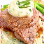 Herb butter filet mignon on a plate.