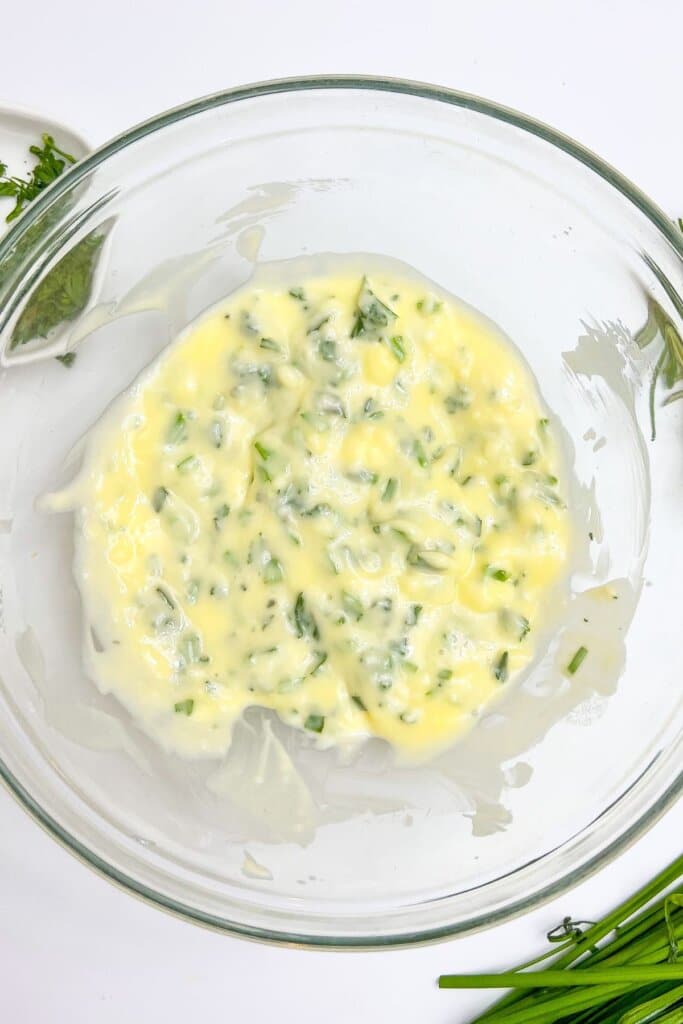 Herbed butter in a glass bowl.