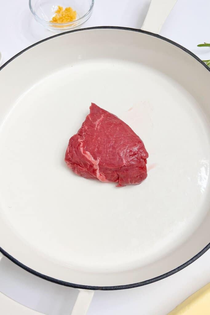 Filet mignon in a skillet.