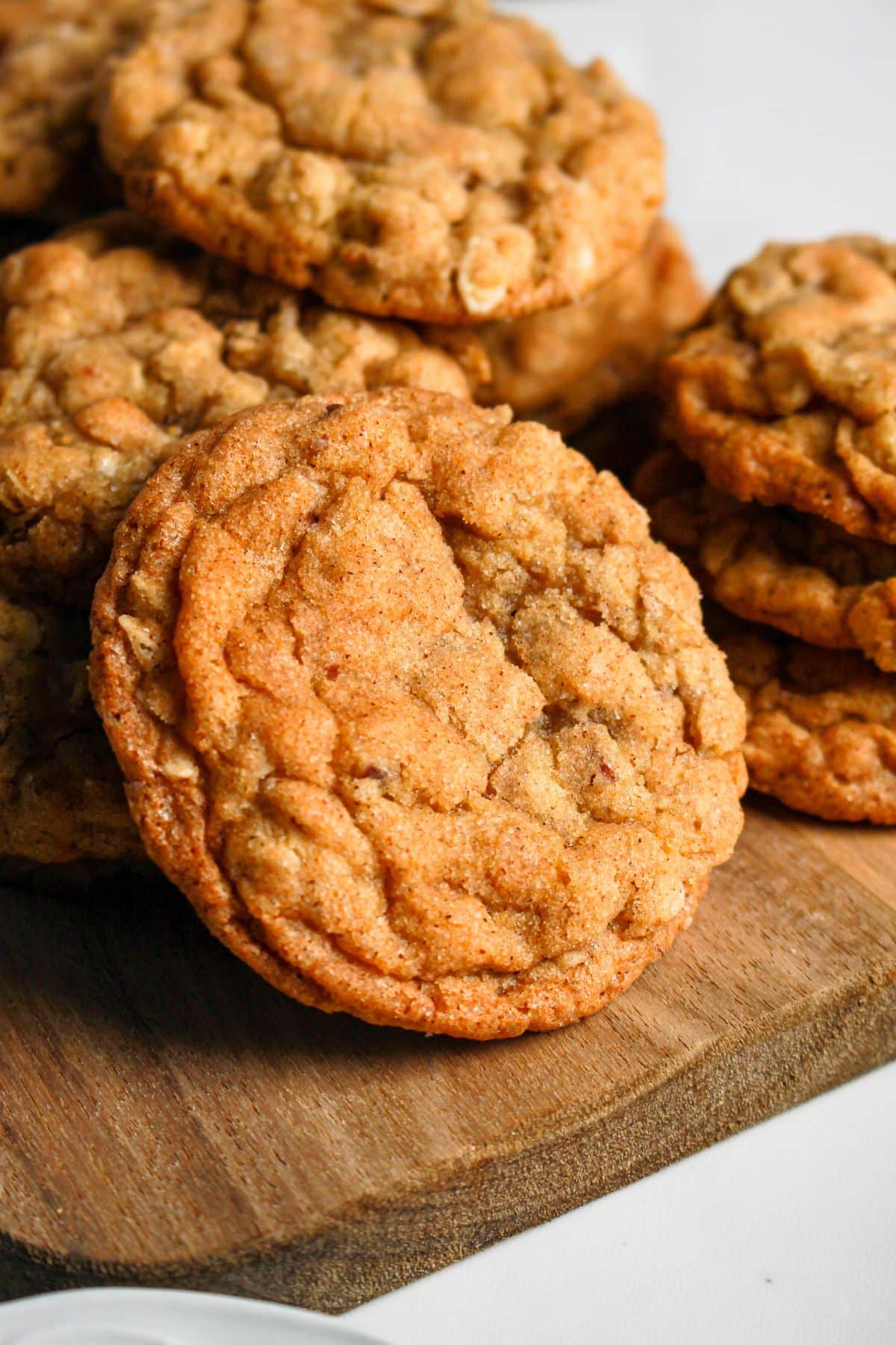Maple oatmeal cookies on a wooden cutting board.