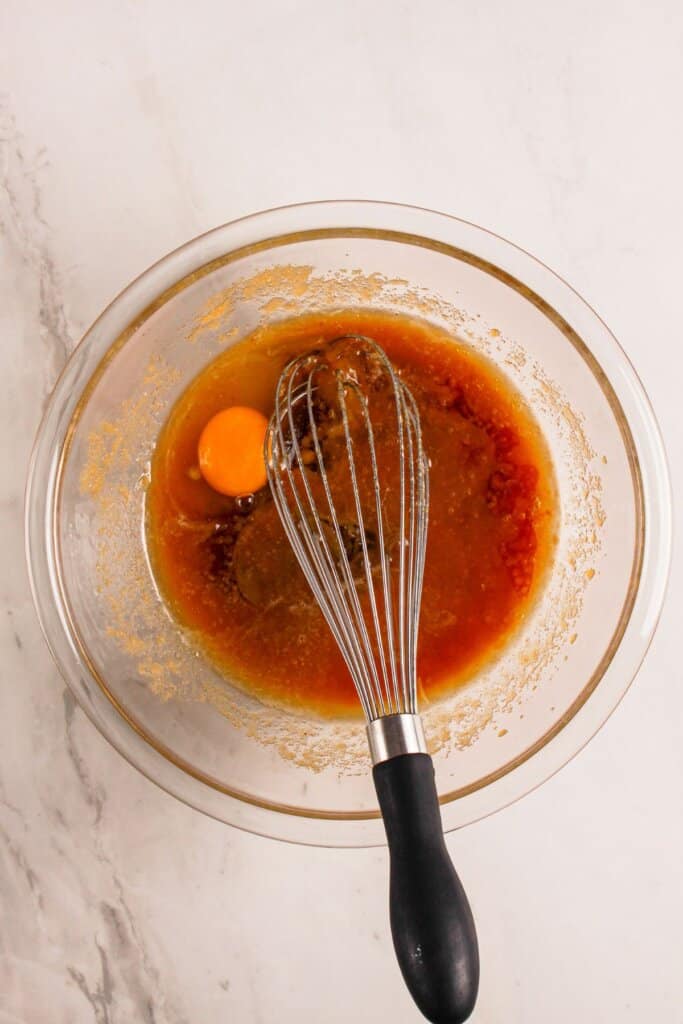 Wet ingredients being mixed into a large bowl.