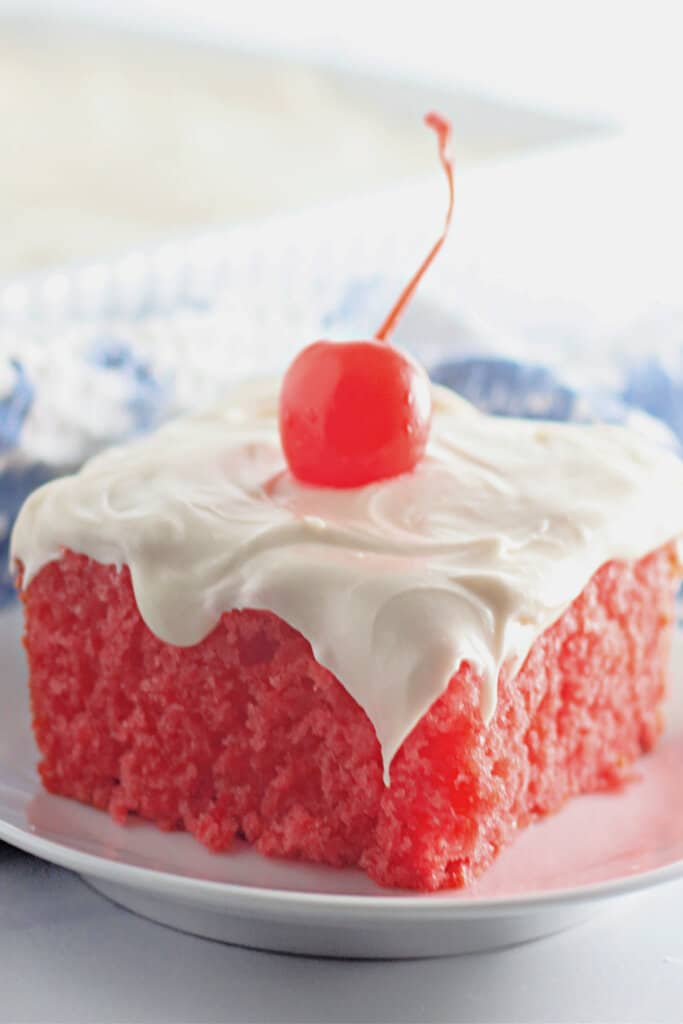 Slice of maraschino cherry cake on a plate.