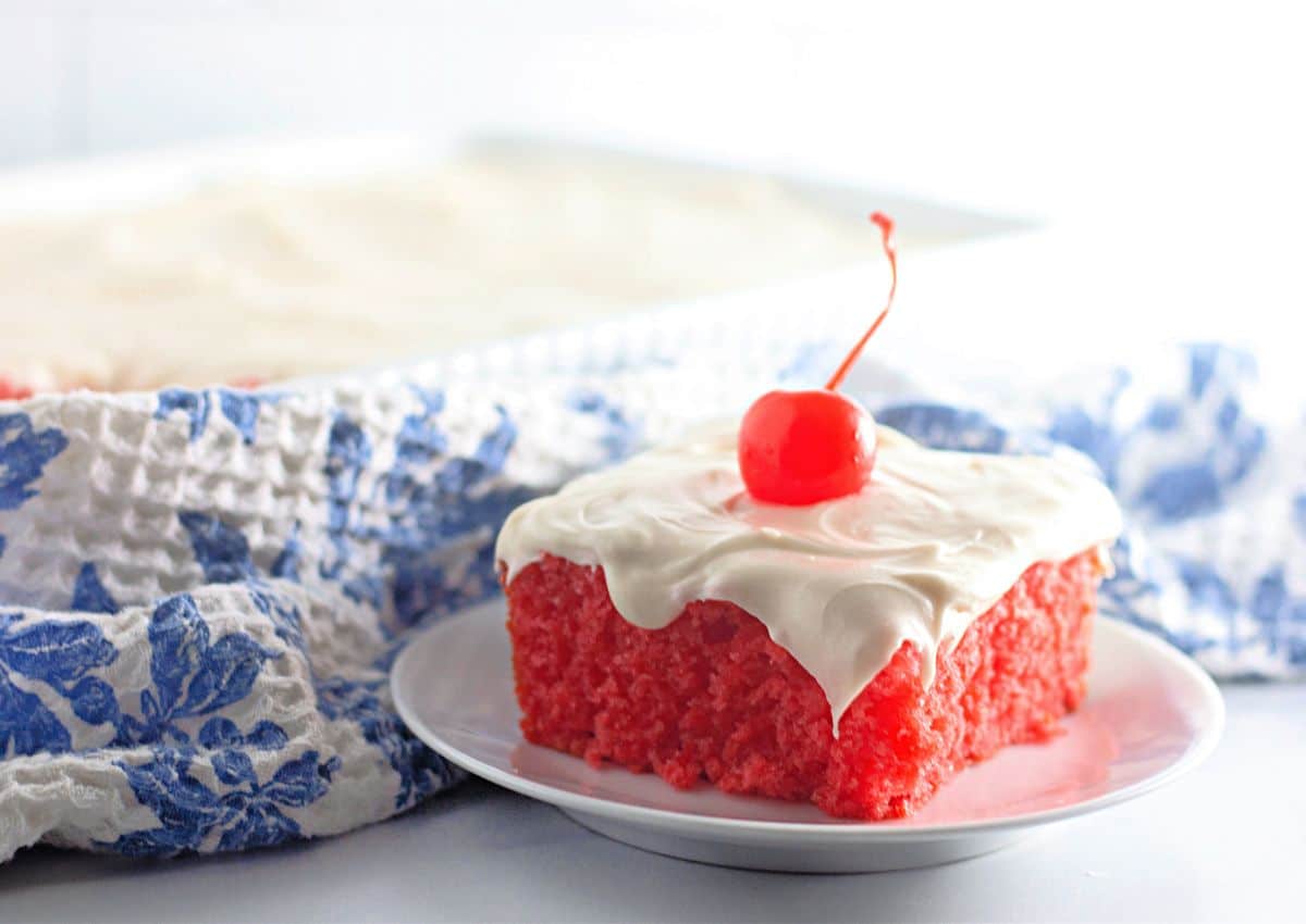 Slice of maraschino cherry cake on a plate.
