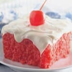 Slice of maraschino cherry cake on a plate.