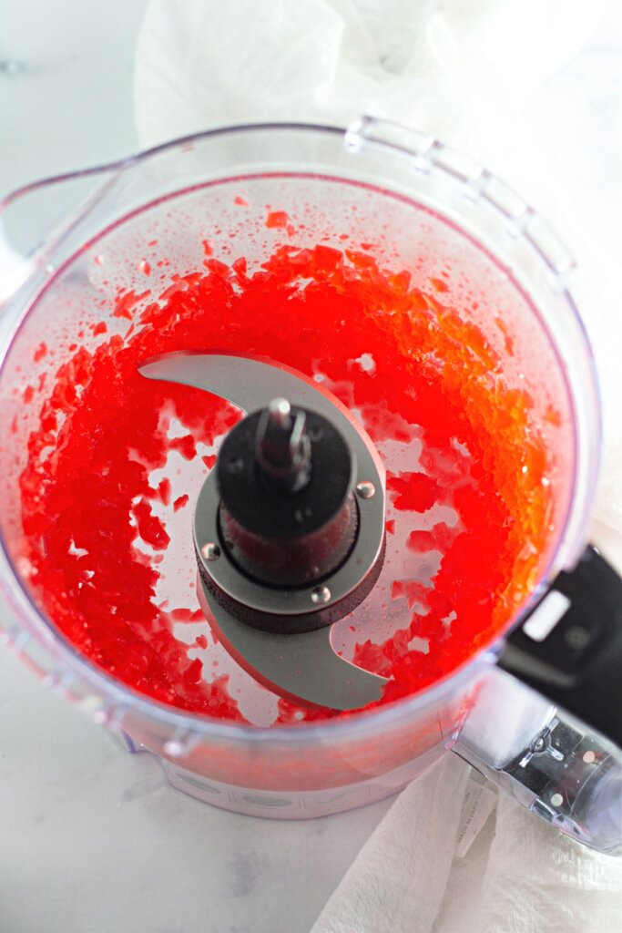 Cherries being chopped in a food processor.