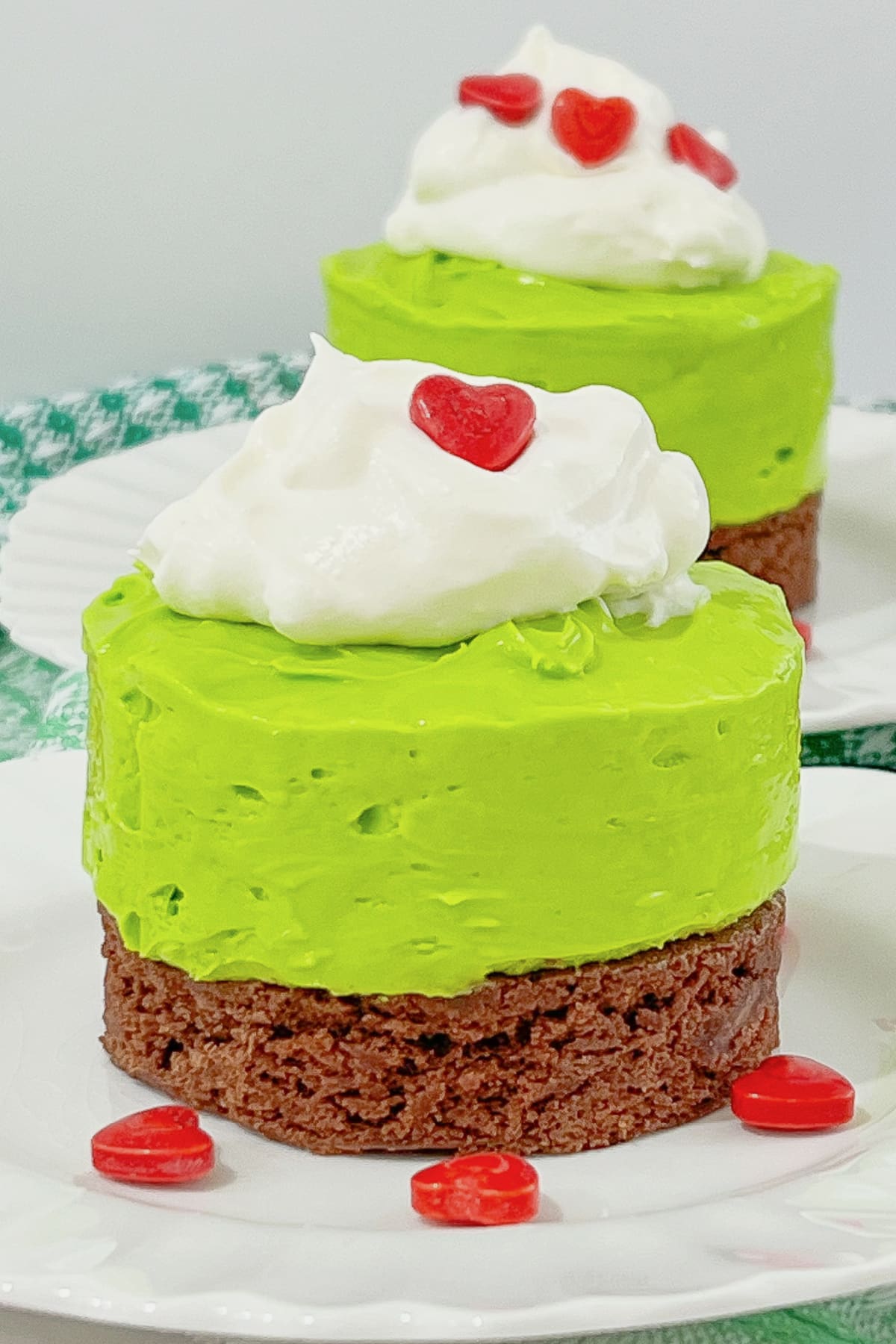 Mini grinch cheesecakes on a plate.