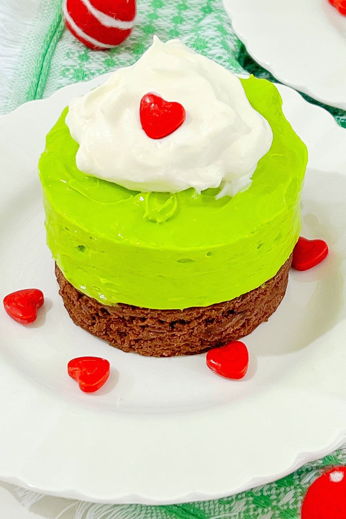 Mini grinch cheesecakes on a plate.