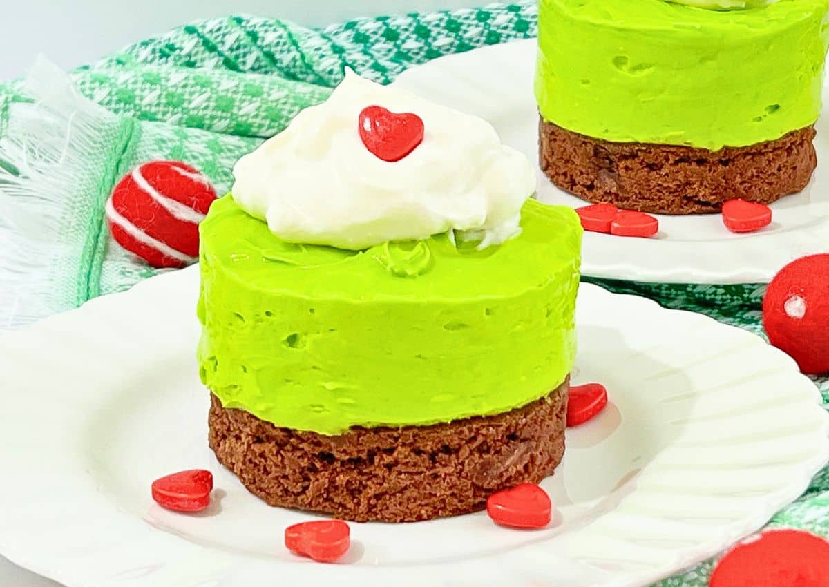 Mini grinch cheesecakes on a plate.