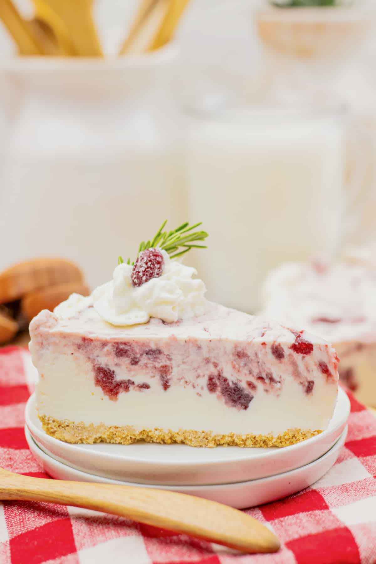 Slice of cranberry cheesecake on a plate.