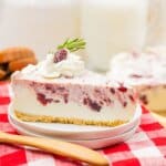 Slice of cranberry cheesecake on a plate.