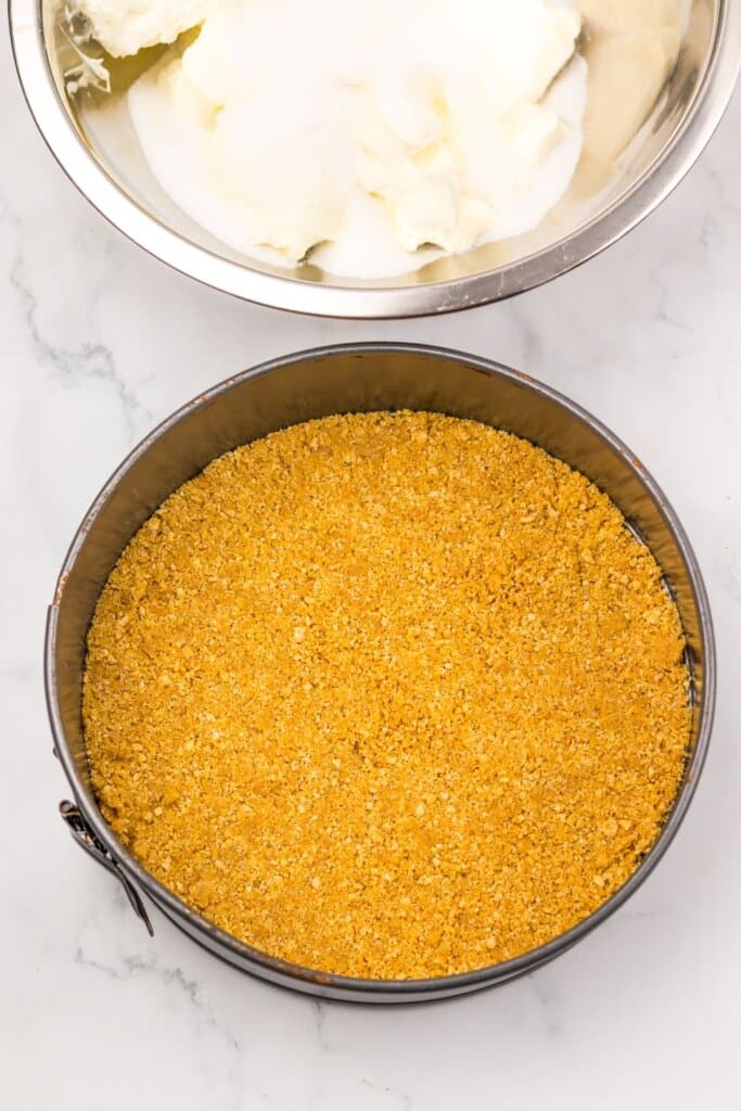 Graham cracker crust in a springform pan.