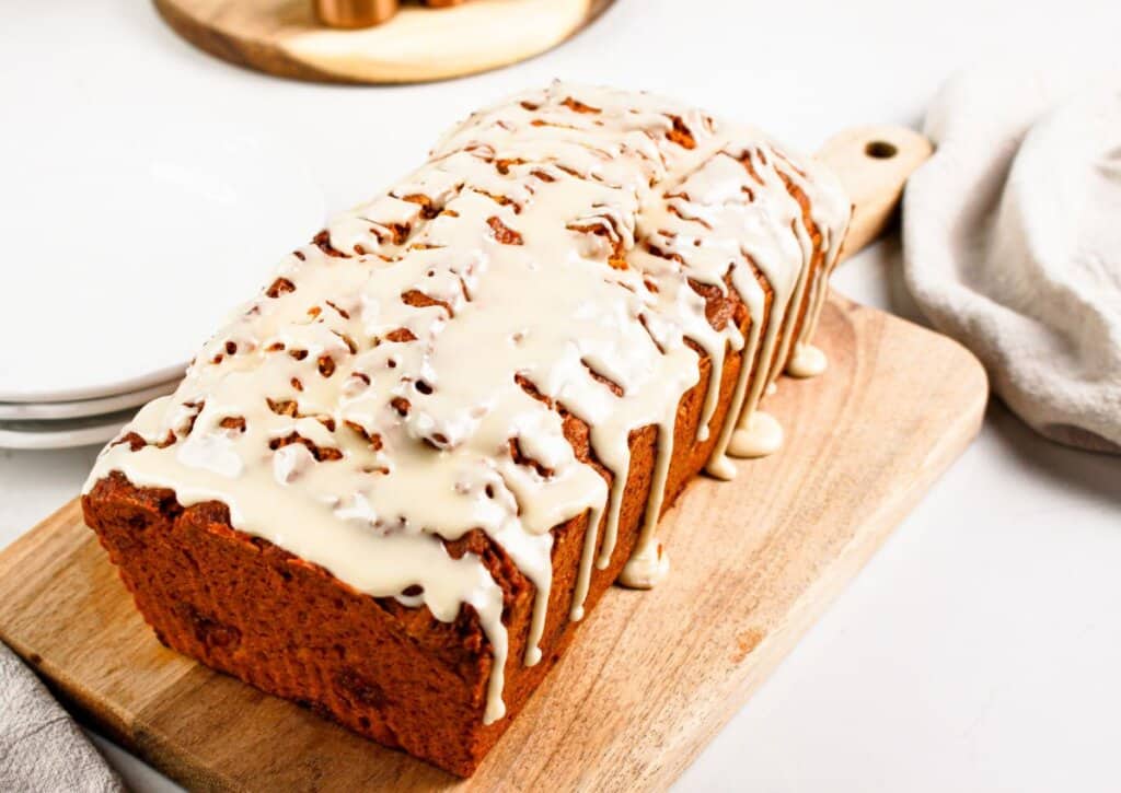 Loaf of pumpkin butterscotch bread on a cutting board.