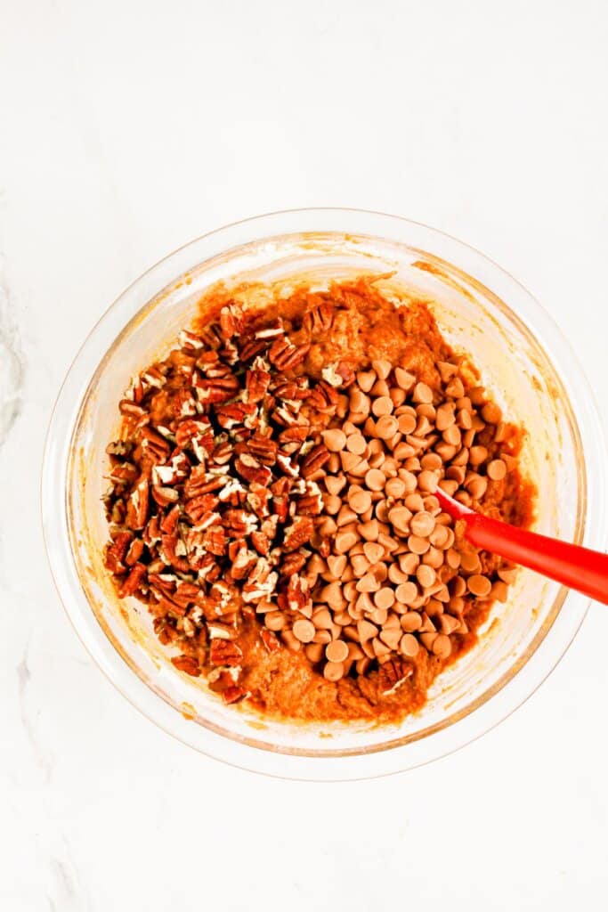 Butterscotch chips and pecans in a mixing bowl.