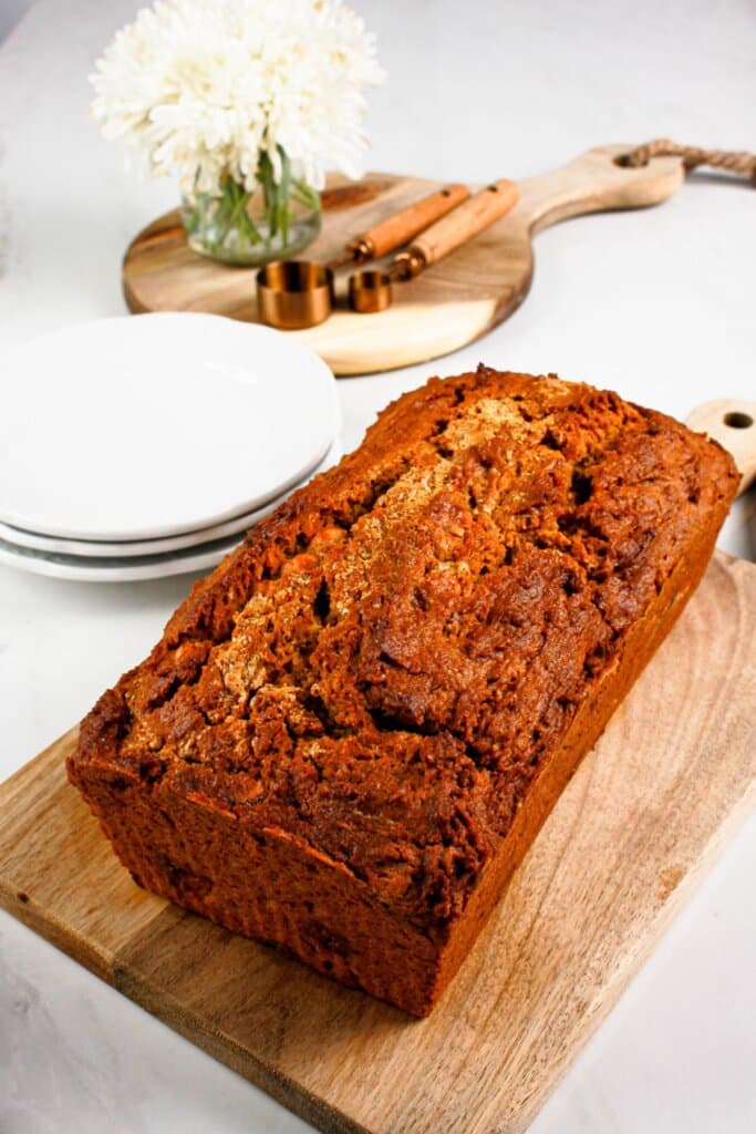 Loaf of pumpkin butterscotch bread on a cutting board.