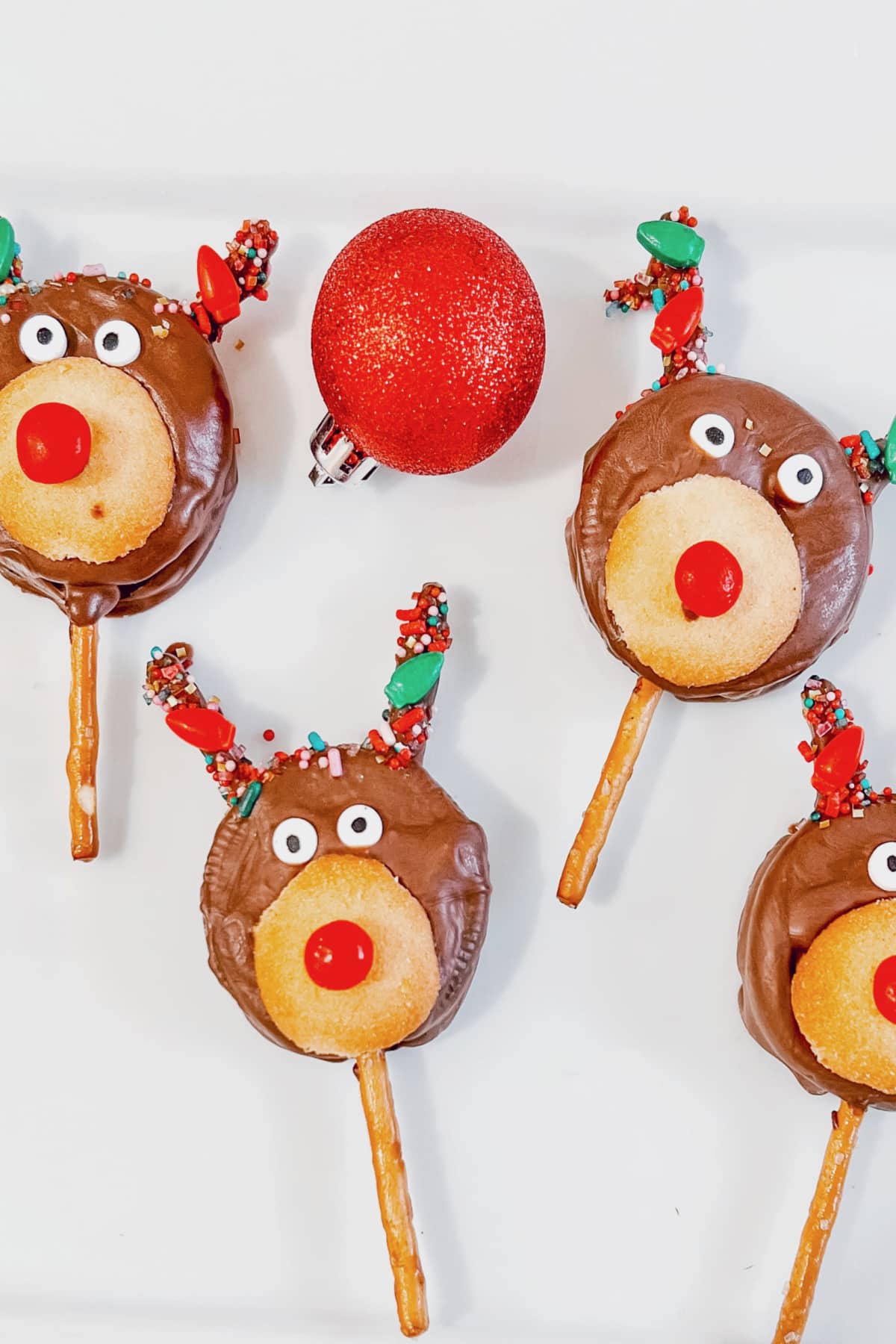 Reindeer Oreo pops are on a white plate.