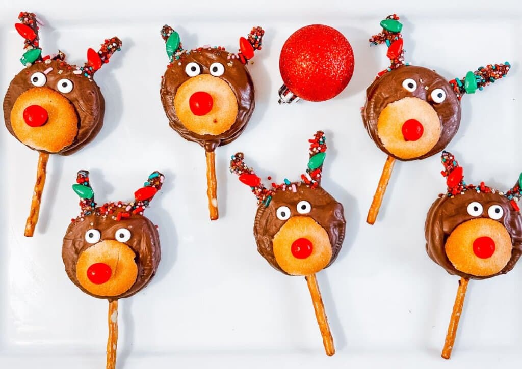 Reindeer Oreo pops are on a white plate.