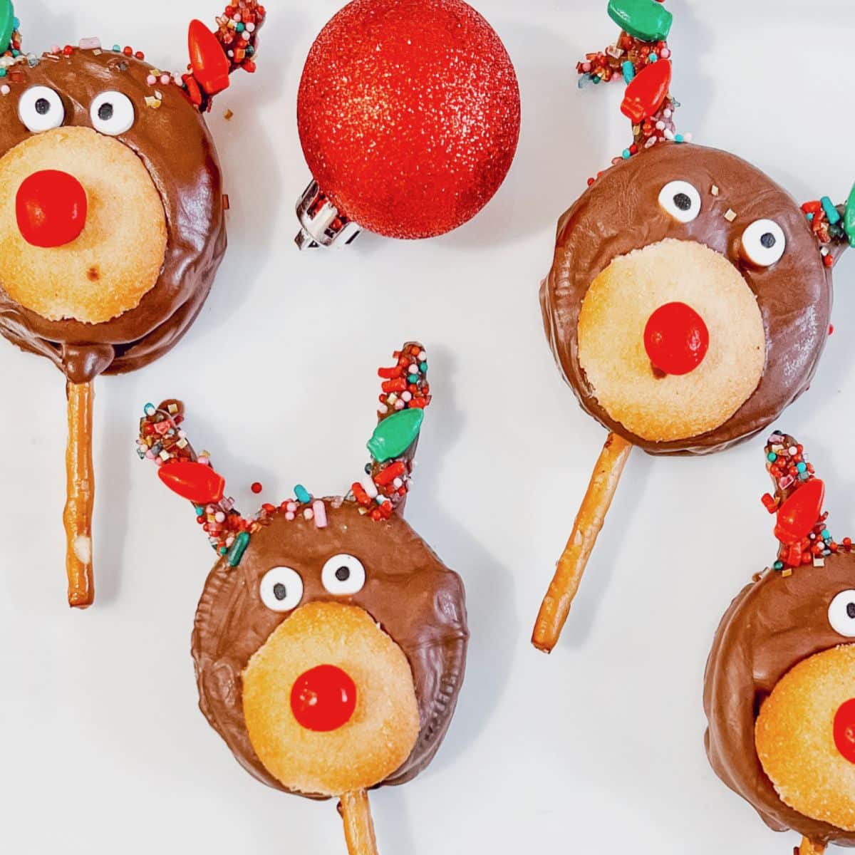 Reindeer Oreo pops are on a white plate.