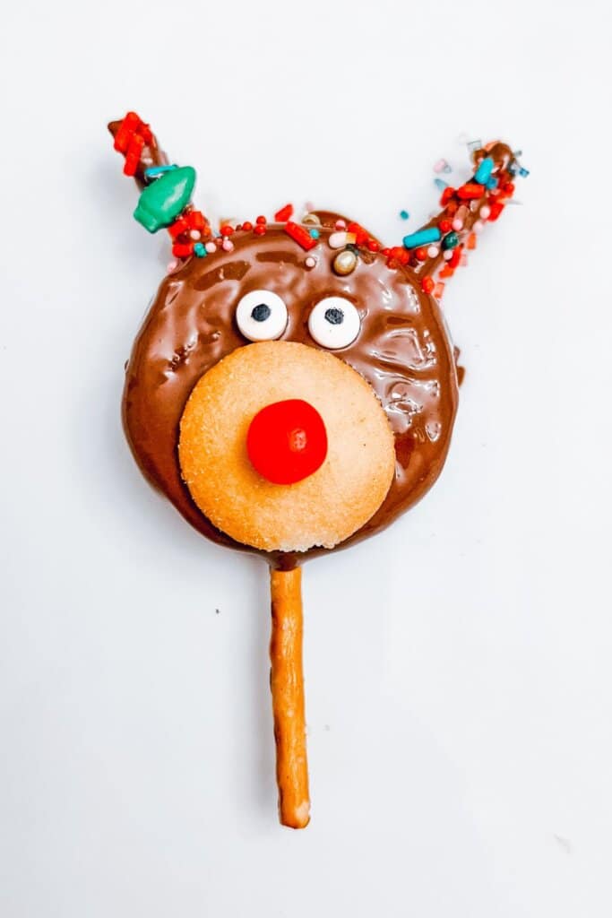 Reindeer Oreo pops are on a white plate.