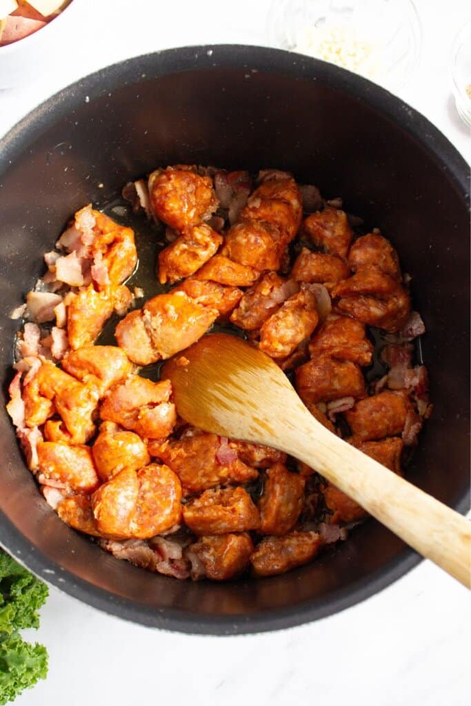 Sausage and bacon in a pot.