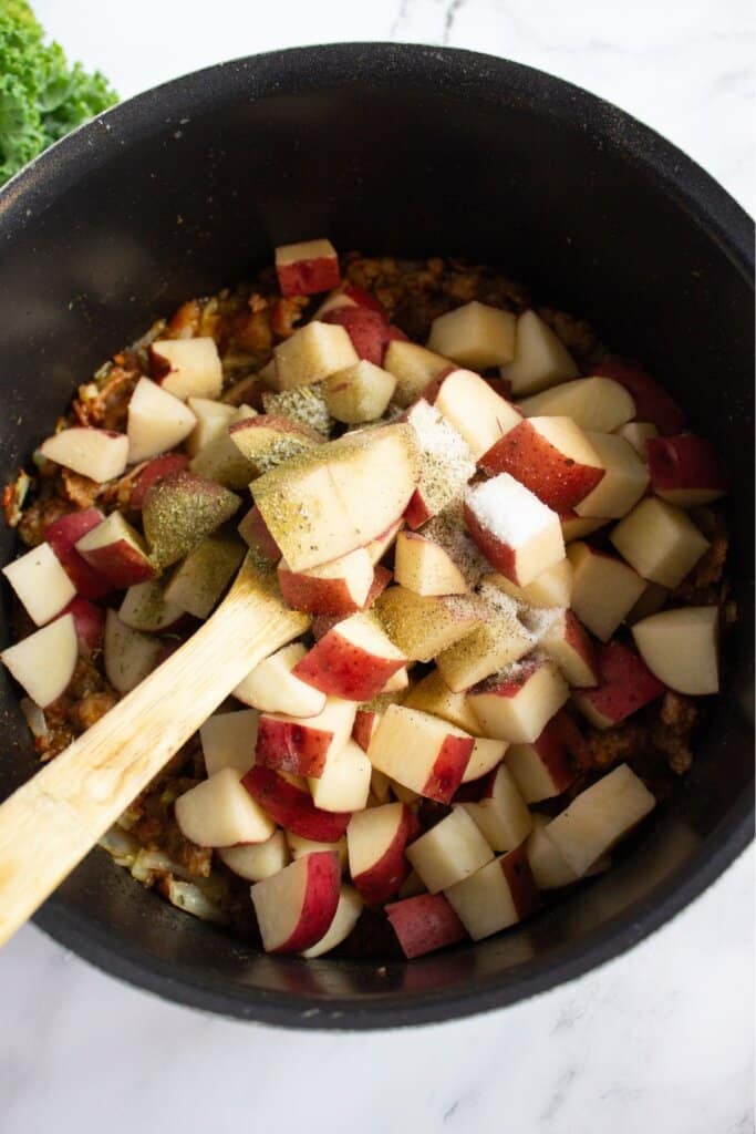 Potatoes and seasonings in a pot.