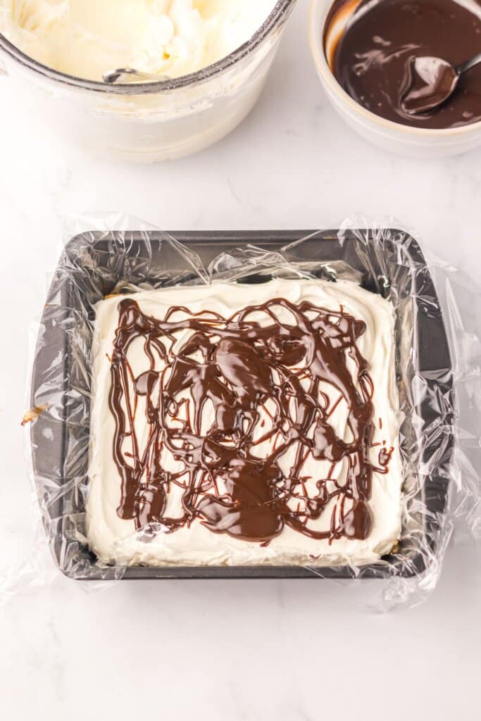 Dessert being layered in a baking dish.