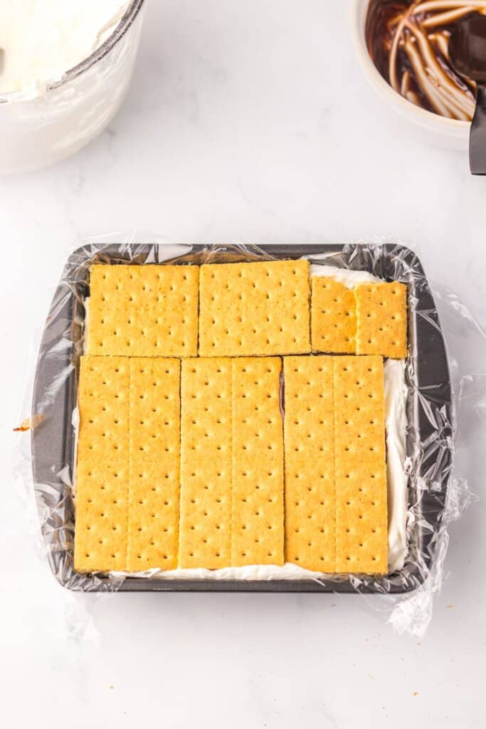 Graham crackers on top of a dessert in a baking dish.
