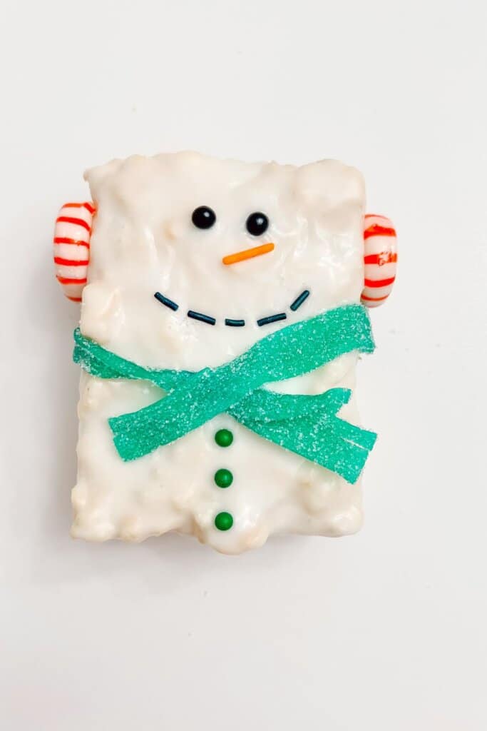 Snowman Rice Krispie treat on a plate.