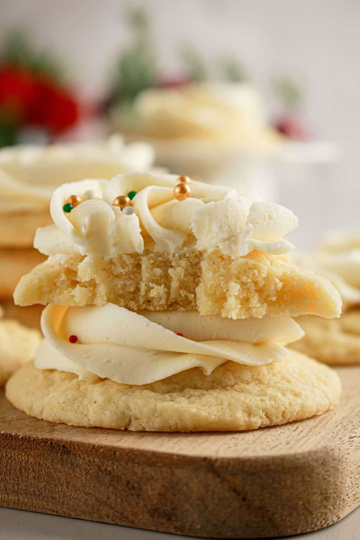 Soft frosted sugar cookies on a cutting board.