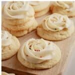 Soft frosted sugar cookies on a cutting board.