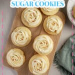 Soft frosted sugar cookies on a cutting board.