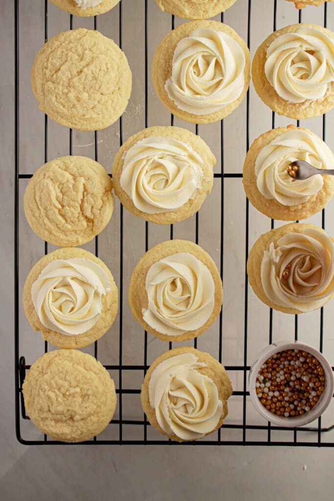 Desserts being frosted on wire rack.
