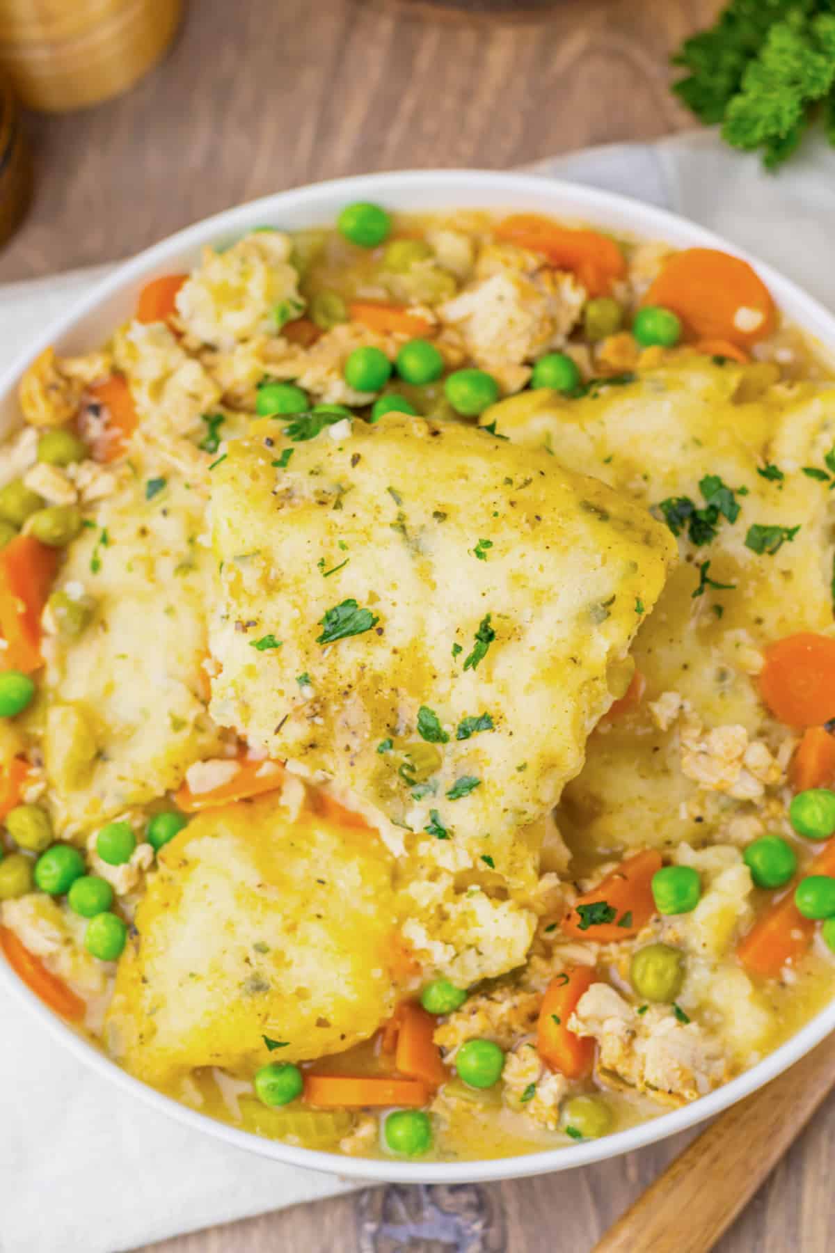 Bowl of turkey and dumplings on a counter.