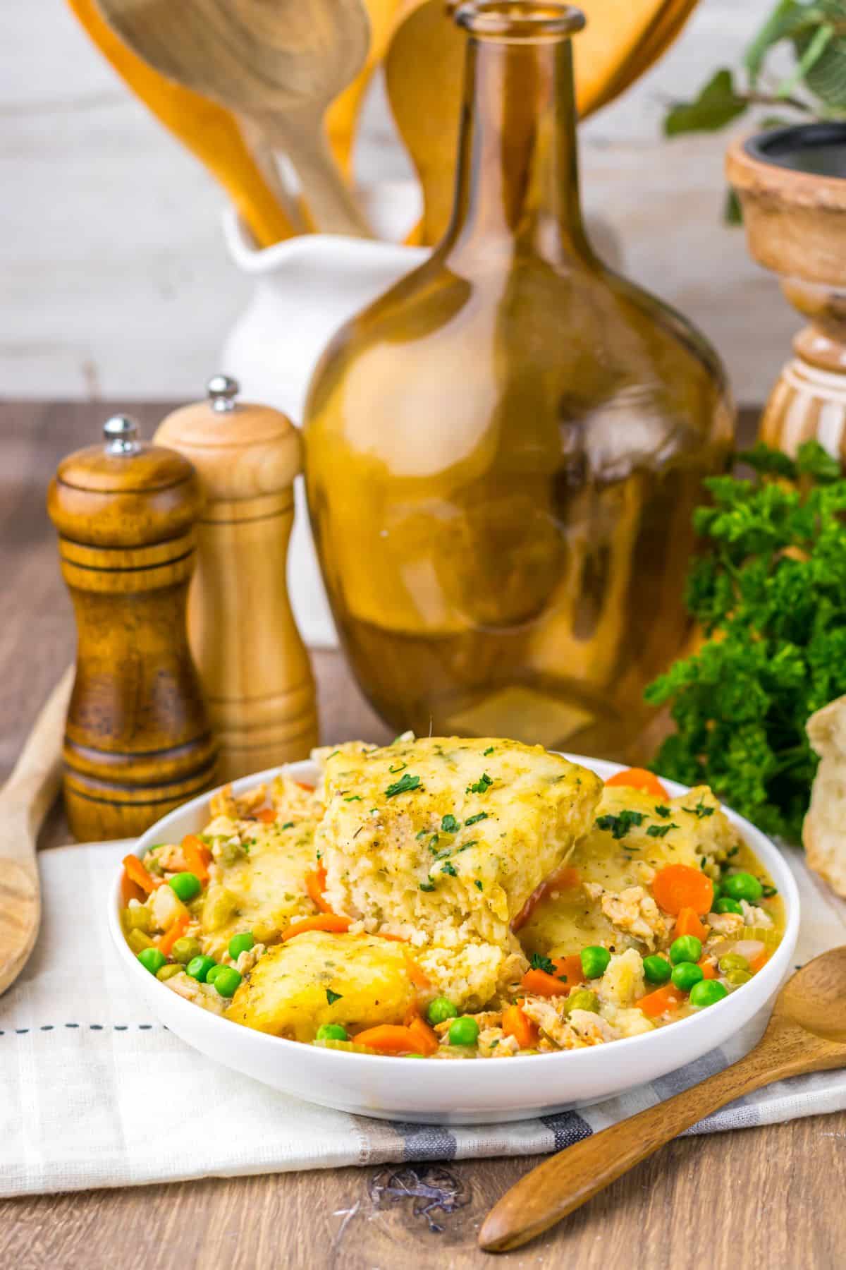 Bowl of turkey and dumplings on a counter.