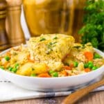 Bowl of turkey and dumplings on a counter.