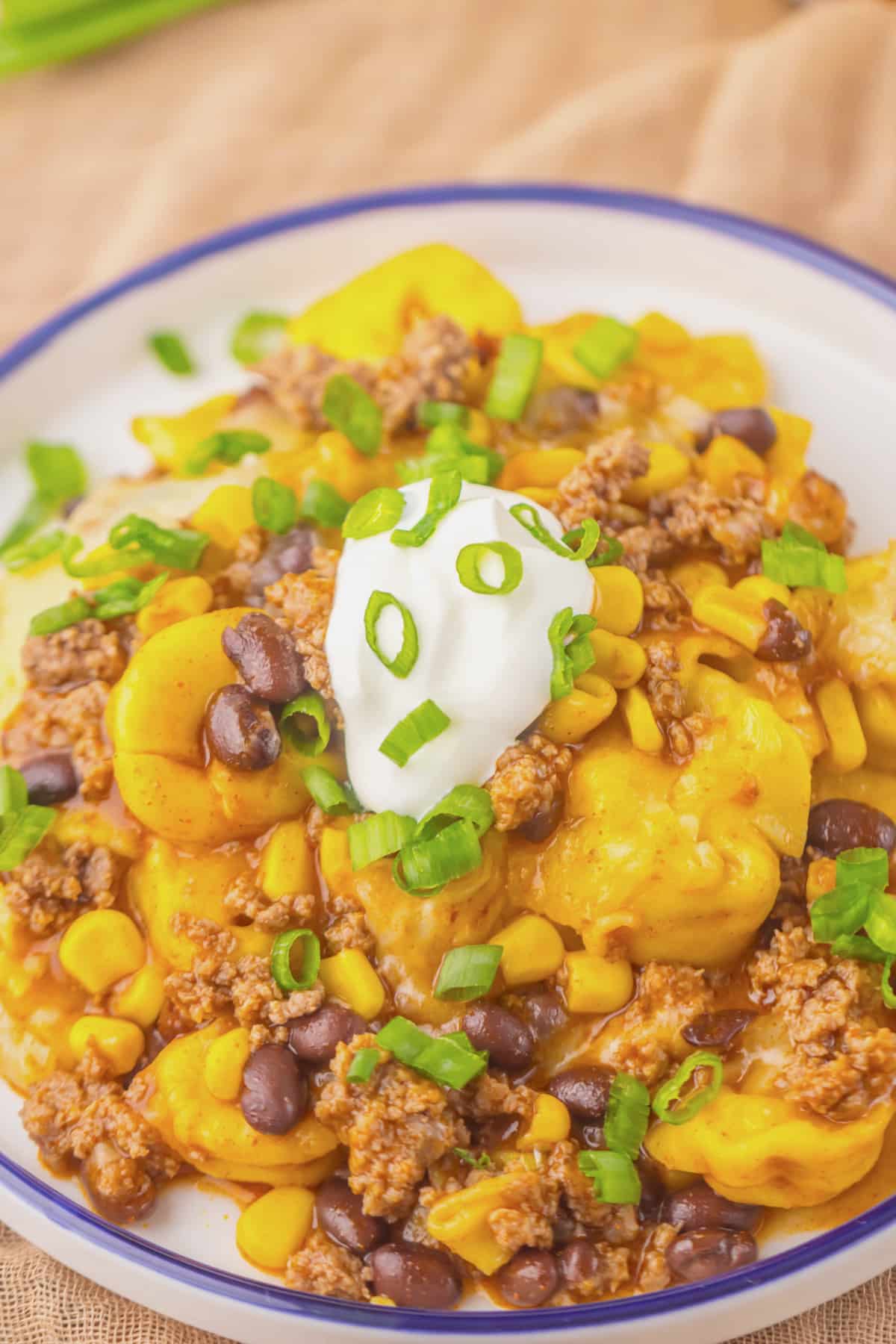 Plate full of beef enchilada tortellini on table.