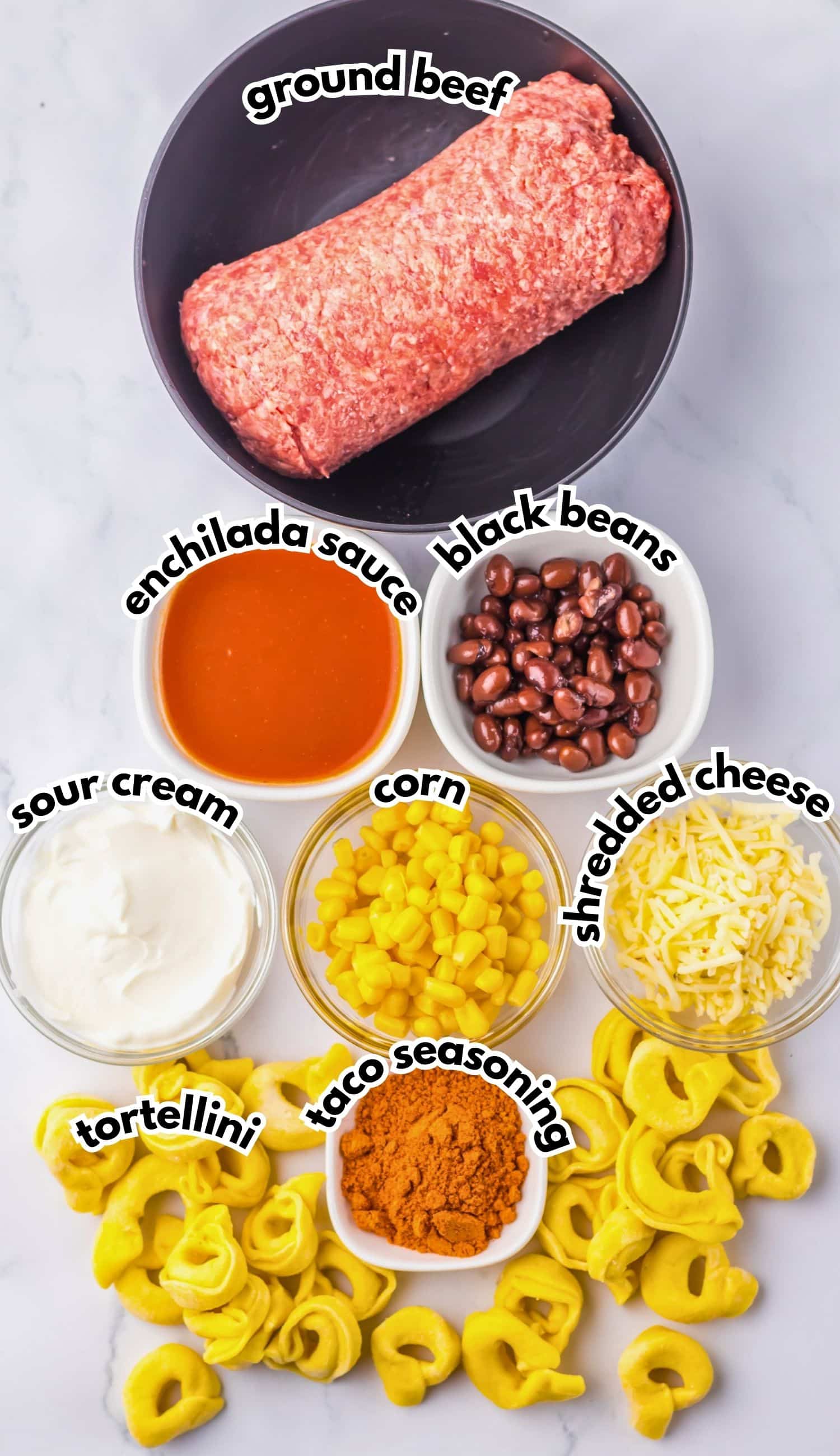 Bowls of ingredients labelled with text on a counter.