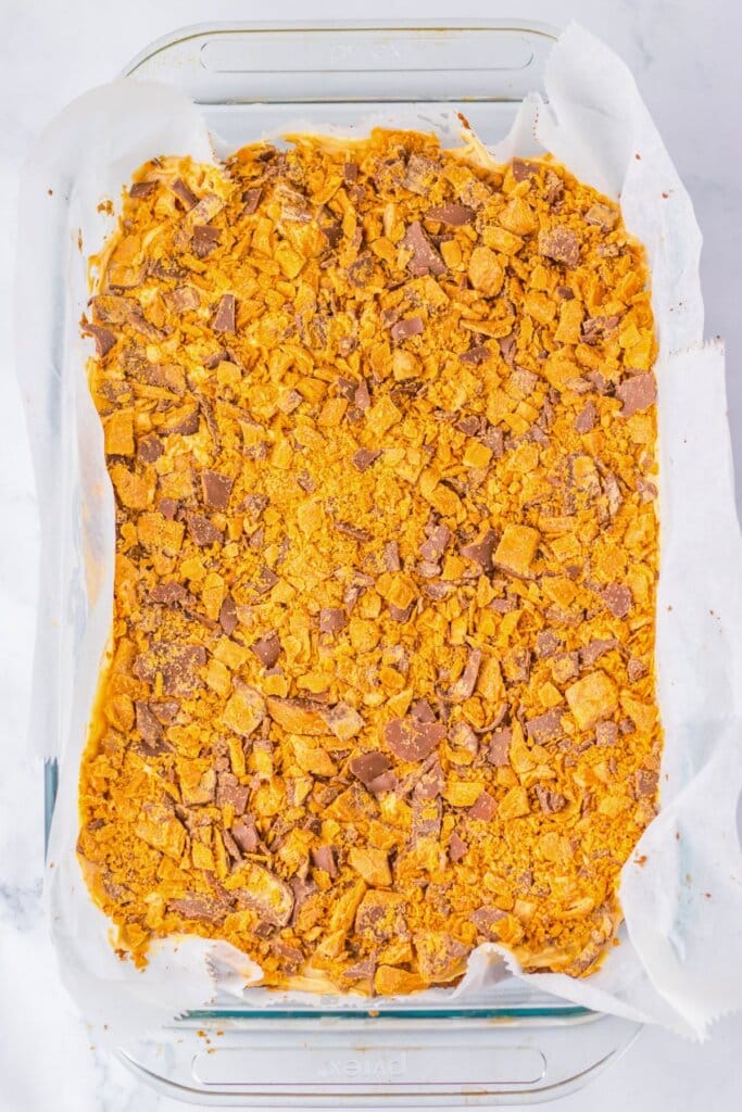 Chopped candy on top of dessert in a glass baking dish.