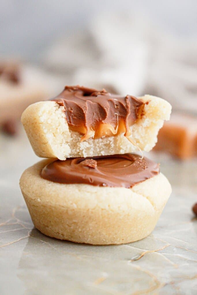 Two caramel cookie cups stacked on top of each other.