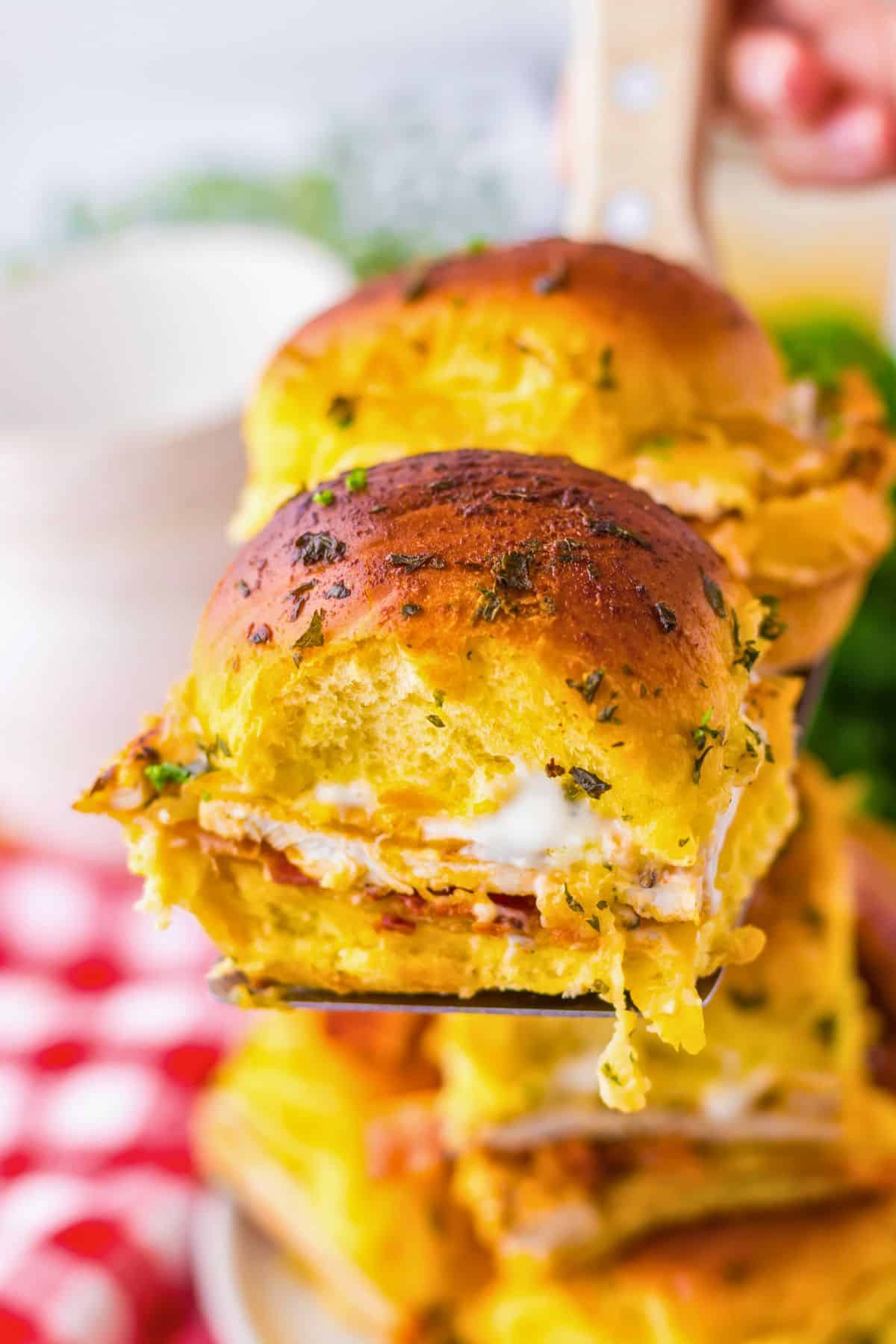Two chicken bacon ranch sliders on a spatula.