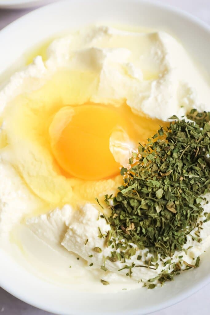 Ricotta and egg being mixed together.