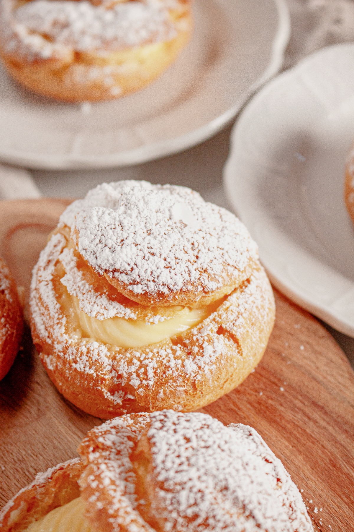 Cream puffs on a wooden lazy susan.